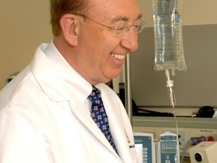 A smiling doctor in a white coat