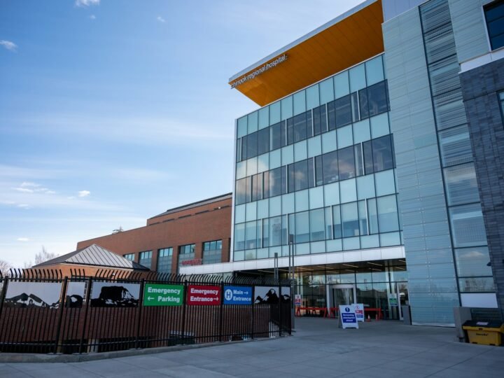 A hospital building with emergency entrance signs