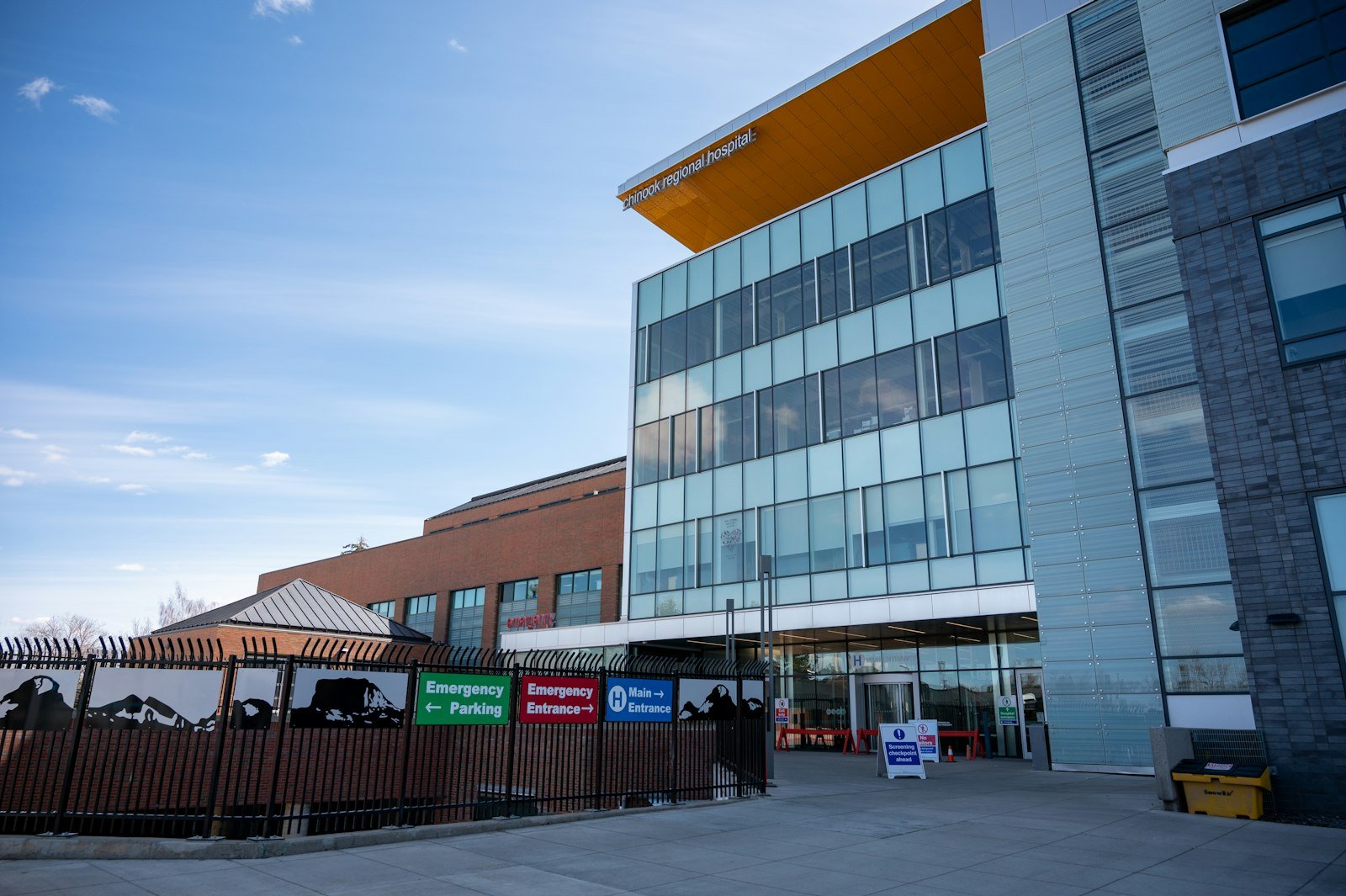 A hospital building with emergency entrance signs